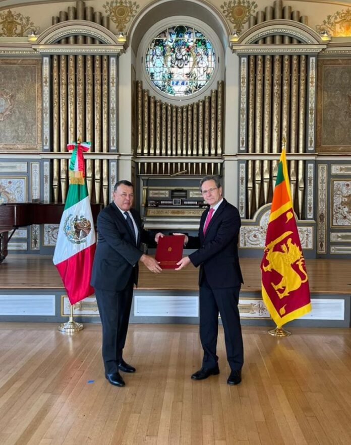 Ambassador Samarasinghe presents copies of his letter of credence as ...