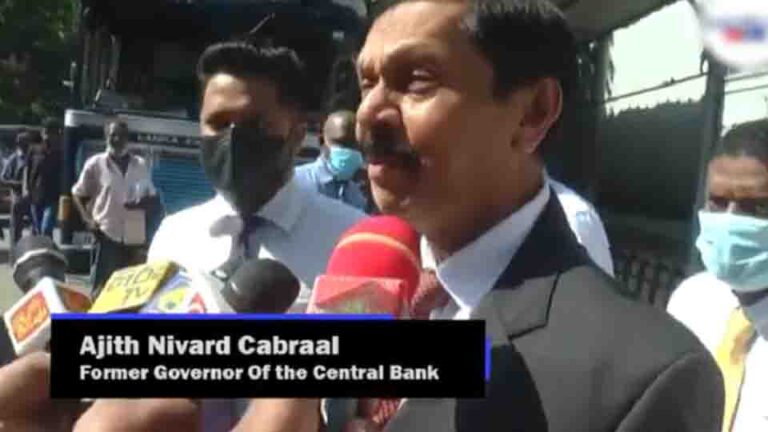 Former CBSL Chief Cabraal urges critics to ‘read his book first,’ seen distributing copies