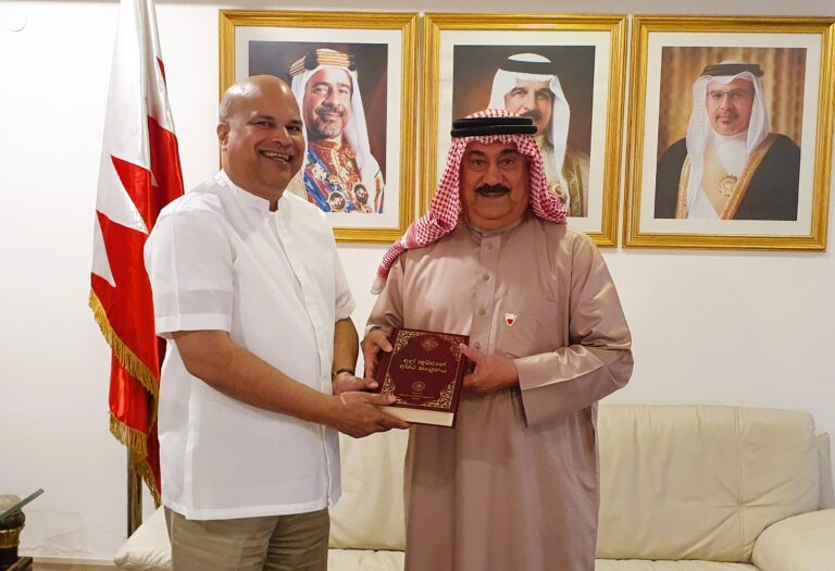 High Commissioner Moragoda presents a copy of the Sinhala translation of the Holy Quran to the Ambassador of Bahrain